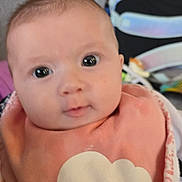 Méora participe au concours pour gagner de l'argent avec cette photo : baby, infant, face, eyes, cheeks, bib, portrait, close_up, pink_bib, smile, indoor, baby_gear, backpack, stroller, soft_skin, young_child, cute, clothing, sitting, curious_expression