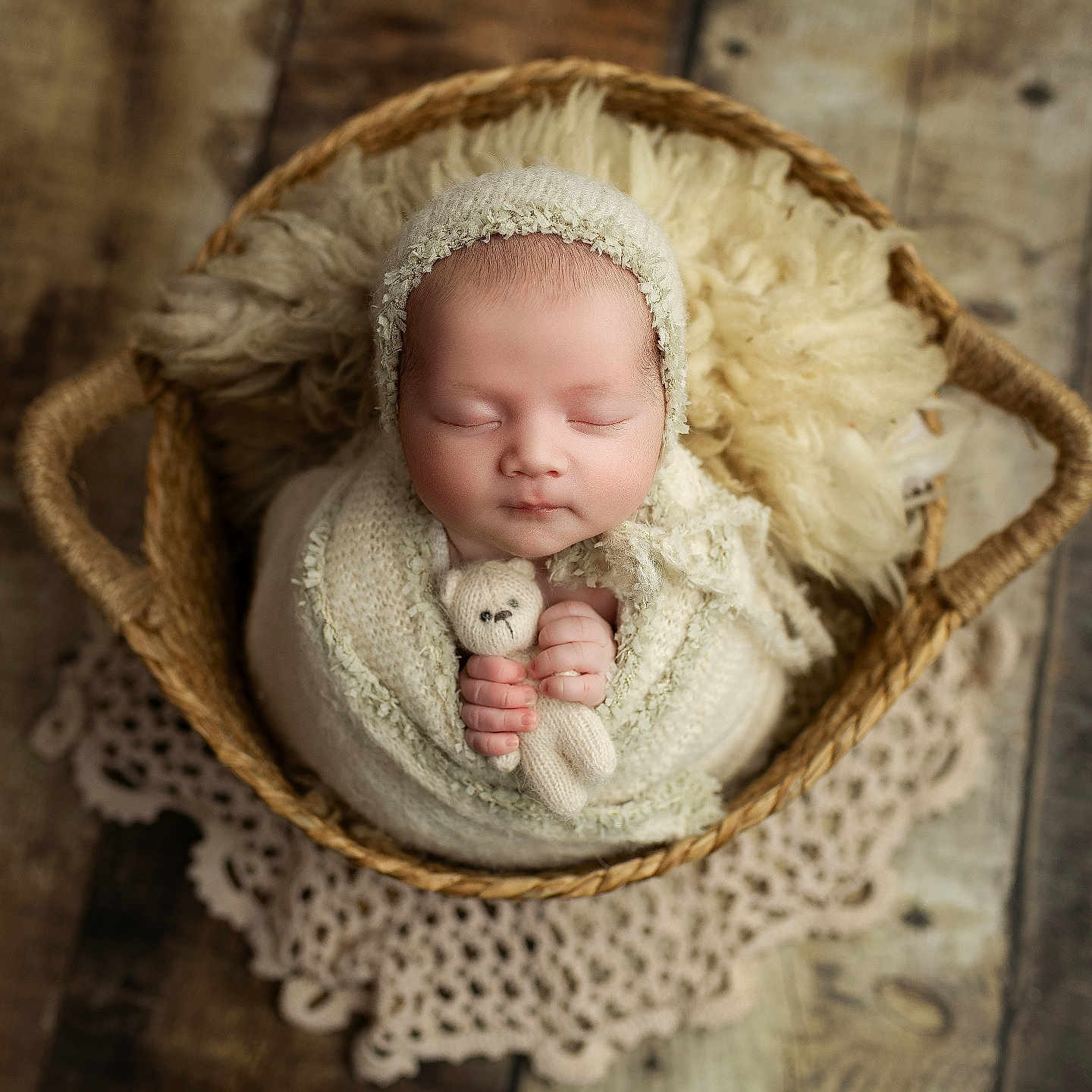 Méora participe au concours pour gagner de l'argent avec cette photo : baby, basket, closed_eyes, cozy, doily, fur_blanket, hands, infant, knitted_hat, newborn, newborn_photography, peaceful, portrait, prop_photography, sleeping, soft_texture, stuffed_animal, swaddle, toy, wooden_floor