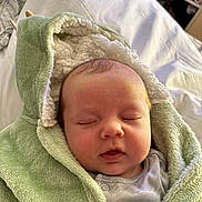 Colby joined the competition — help win amazing prizes! baby, sleeping, blanket, hooded_blanket, green, soft_texture, infant, face, peaceful, cozy, cute, child, newborn, indoors, portrait, cute_baby, resting, toddler, clothing, warm