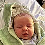 baby, sleeping, blanket, hooded_blanket, green, soft_texture, infant, face, peaceful, cozy, cute, child, newborn, indoors, portrait, cute_baby, resting, toddler, clothing, warm