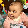 Séléna a rejoint le concours — aidez-le/la à gagner de superbes lots ! baby, child, infant, pink_clothing, toy, colorful, face, eyes, smile, hand, soft_texture, indoor, cute, close_up, portrait, playtime, curious, toddler, furniture, background_blur