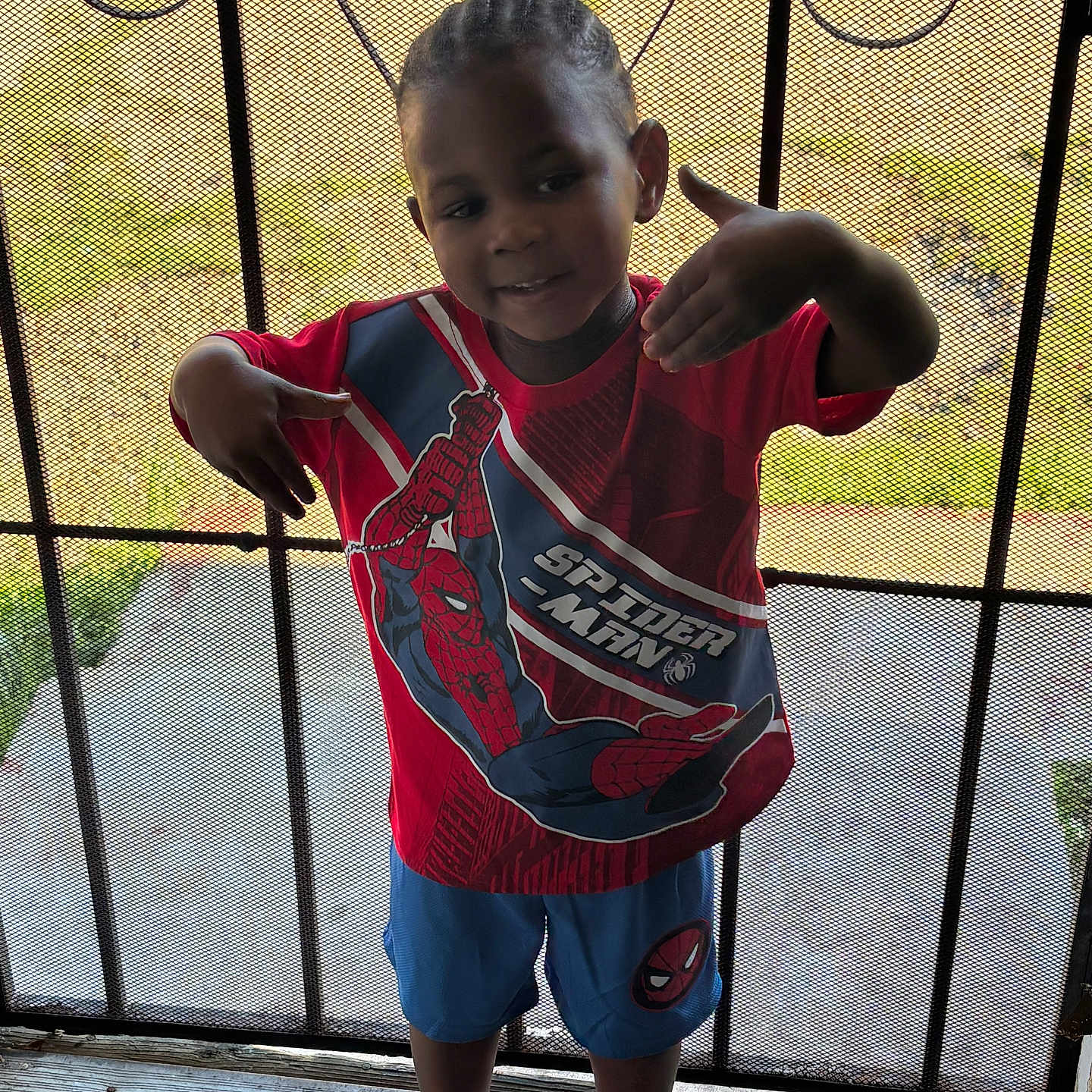 Jamarcus joined the competition — help win amazing prizes! child, boy, smiling, spiderman, tshirt, shorts, sandals, mesh_door, outdoor, playful, hands, portrait, standing, footwear, clothing, casual, hair, person, daylight, background