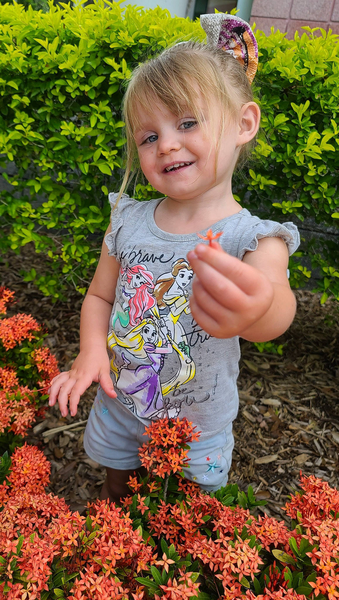 Evah is registered to the contest to win money with this photo: beauty, botany, child, flower, grass, groundcover, happy, joy, leaf, nature, orange, people_in_nature, person, petal, photograph, plant, red, smile, summer, t_shirt