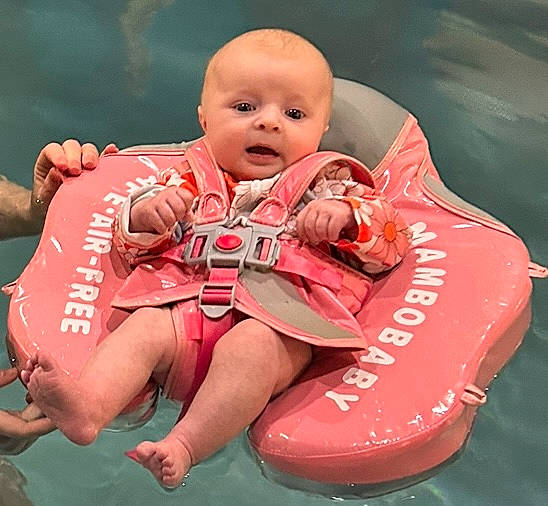 Gia is registered to the contest to win money with this photo: baby, baby_products, baby_toddler_clothing, carmine, comfort, event, finger, fun, grass, happy, lap, leisure, person, personal_protective_equipment, pink, play, recreation, sitting, smile, thigh