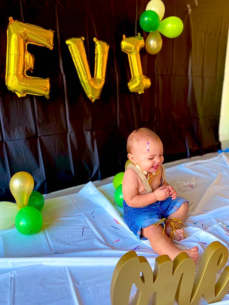 Levi joined the competition — help win amazing prizes! baby, baby_toddler_clothing, balloon, child, comfort, event, fun, green, happy, leisure, party_supply, people, person, photograph, product, room, sitting, snapshot, toddler, toy
