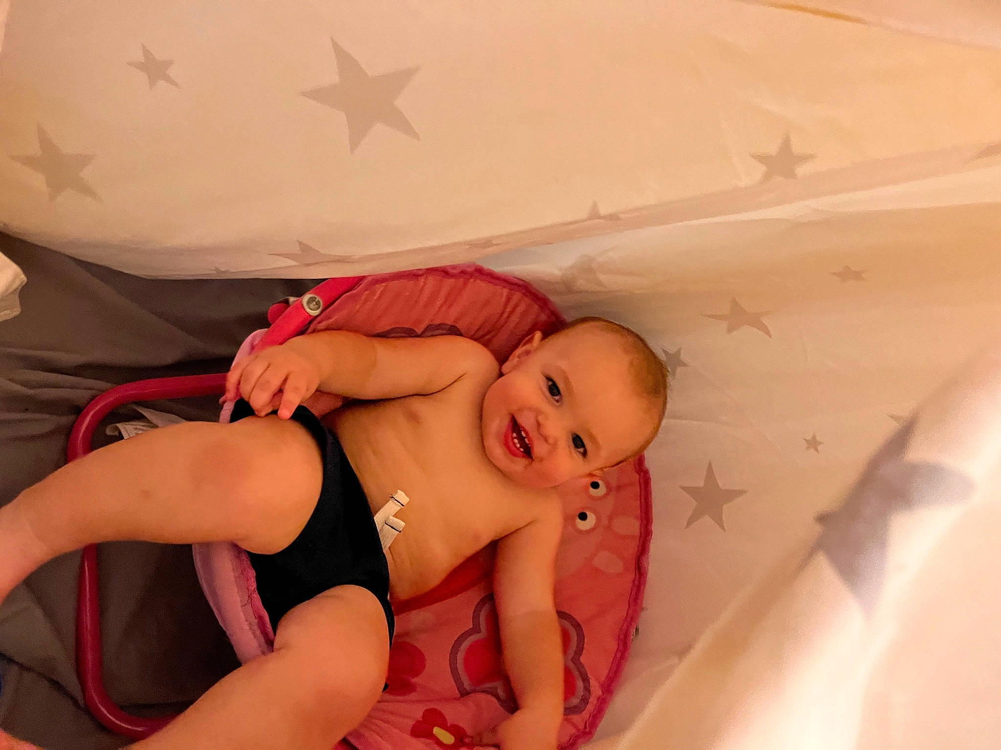 Levi is registered to the contest to win money with this photo: abdomen, arm, baby, barefoot, bed, chest, comfort, diaper, eye, foot, happy, human_body, joy, knee, leg, person, skin, stomach, thigh, thumb
