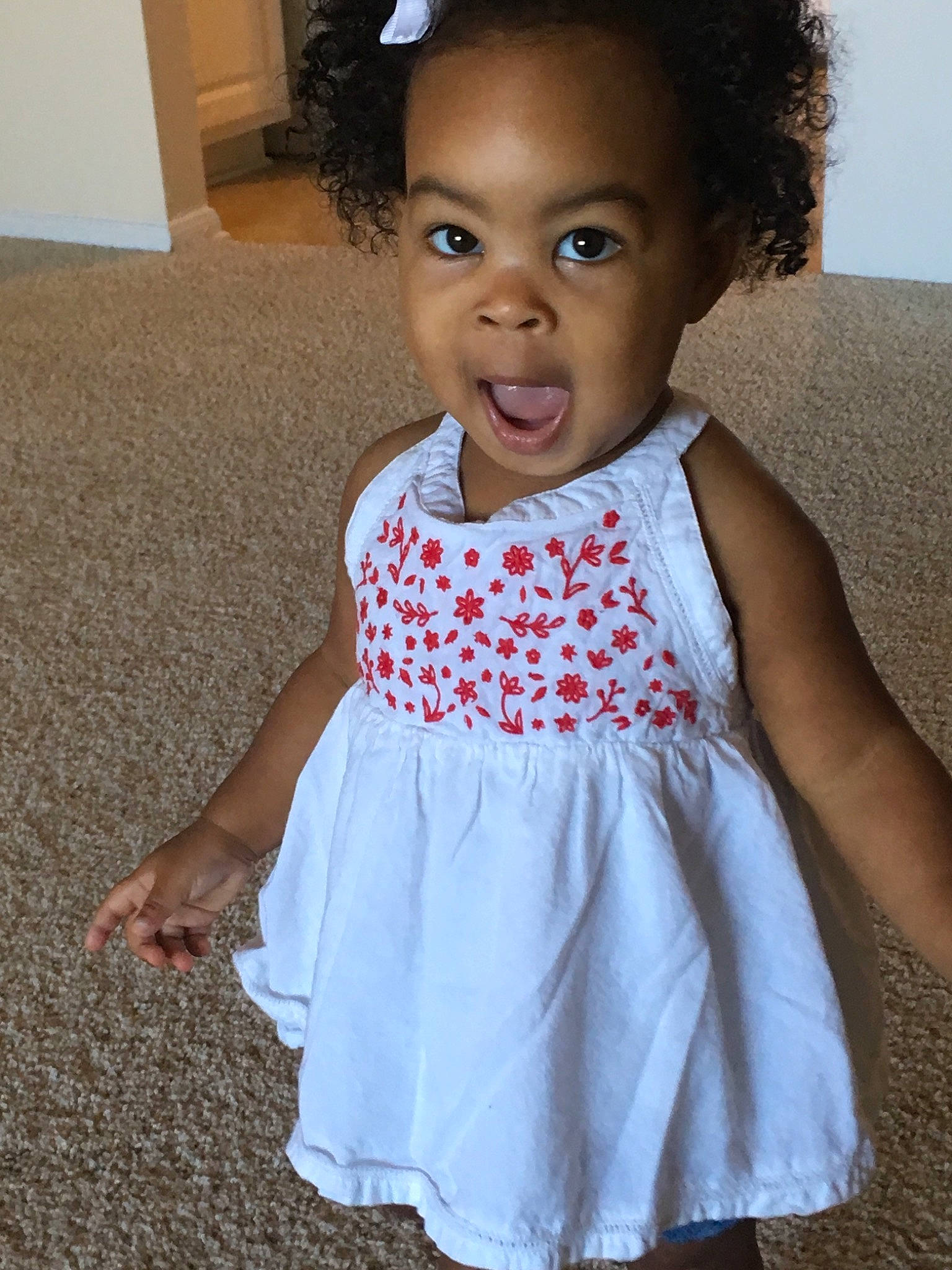 Emarie is registered to the contest to win money with this photo: child, clothing, day, design, dress, girl, hair_accessory, infant, material, outerwear, pattern, person, smile, standing, textile, toddler