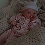 baby, bed, blanket, child, comfort, cozy, cute, hat, indoors, infant, newborn, onesie, person, pillow, resting, sleep, sleepwear, soft_lighting, star_pattern, thumb_sucking