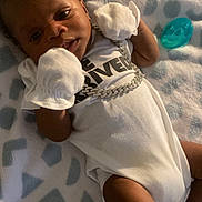 Khavari Williams is registered to the contest to win money with this photo: baby, bed, blanket, bodypart, clothing, cushion, face, finger, furniture, glove, hand, head, homedecor, newborn, person, photography, portrait, quilt, sleeping, t_shirt