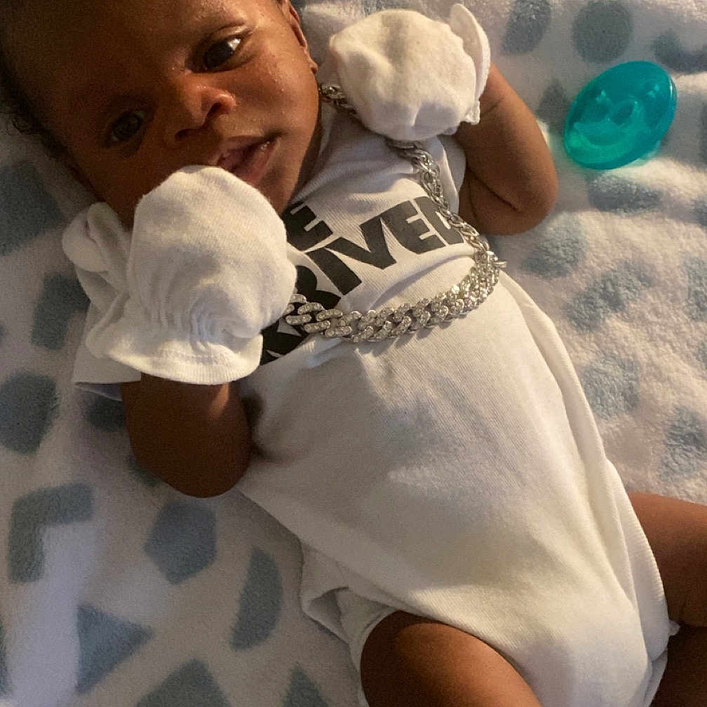 Khavari Williams is registered to the contest to win money with this photo: baby, bed, blanket, bodypart, clothing, cushion, face, finger, furniture, glove, hand, head, homedecor, newborn, person, photography, portrait, quilt, sleeping, t_shirt