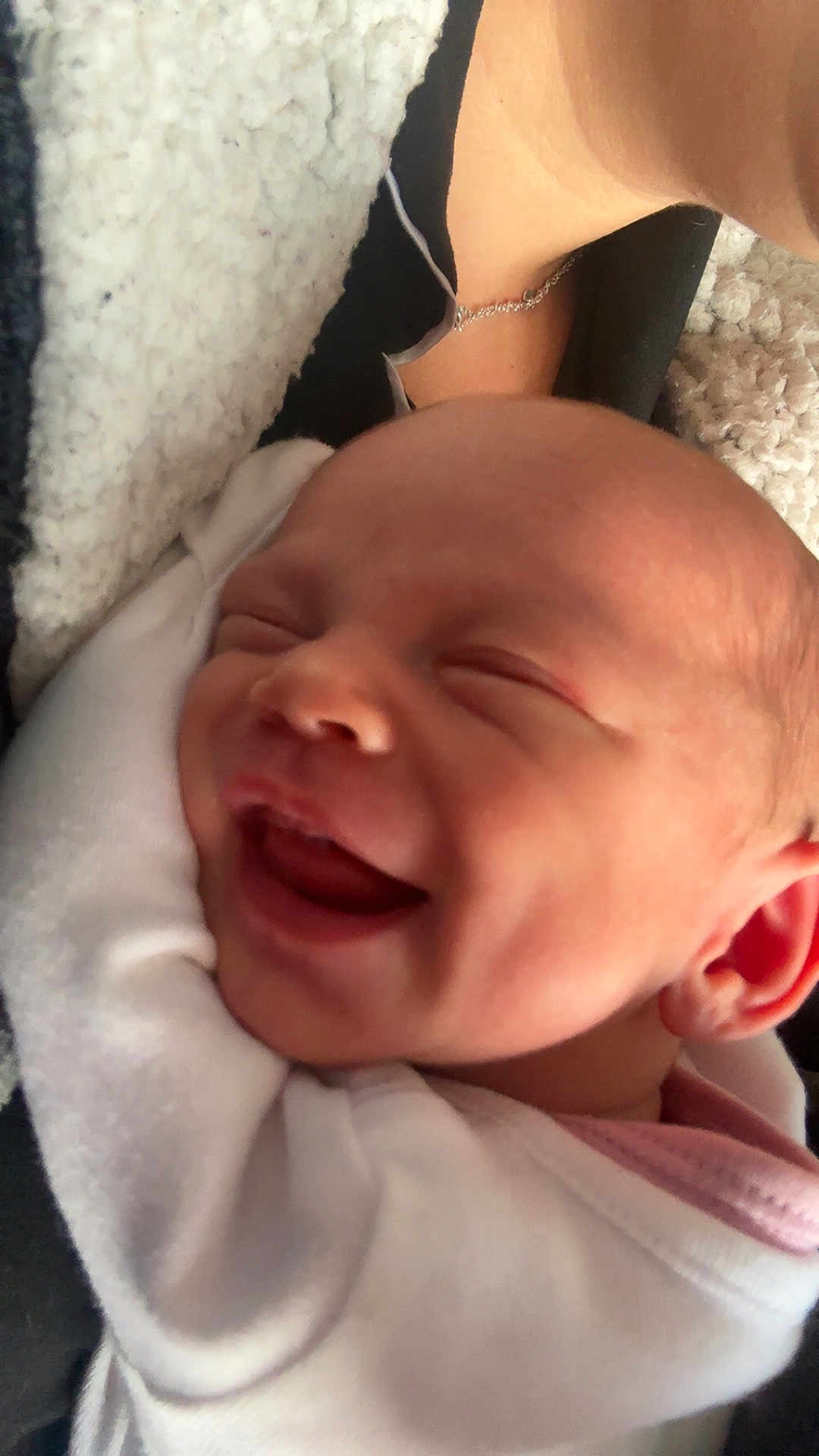 Layla is registered to the contest to win money with this photo: baby, newborn, smiling, infant, face, blanket, white_clothing, closeup, portrait, human, cheerful, soft_texture, skin, ear, mouth, head, sleepy, cute, new_life, warmth