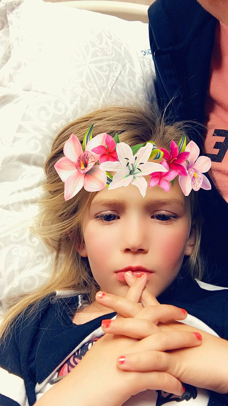 Halle is registered to the contest to win money with this photo: beauty, child, crown, fashion_accessory, finger, flower, gesture, hair_accessory, hand, headgear, headpiece, lip, long_hair, nail, person, petal, photography, pink, plant, skin