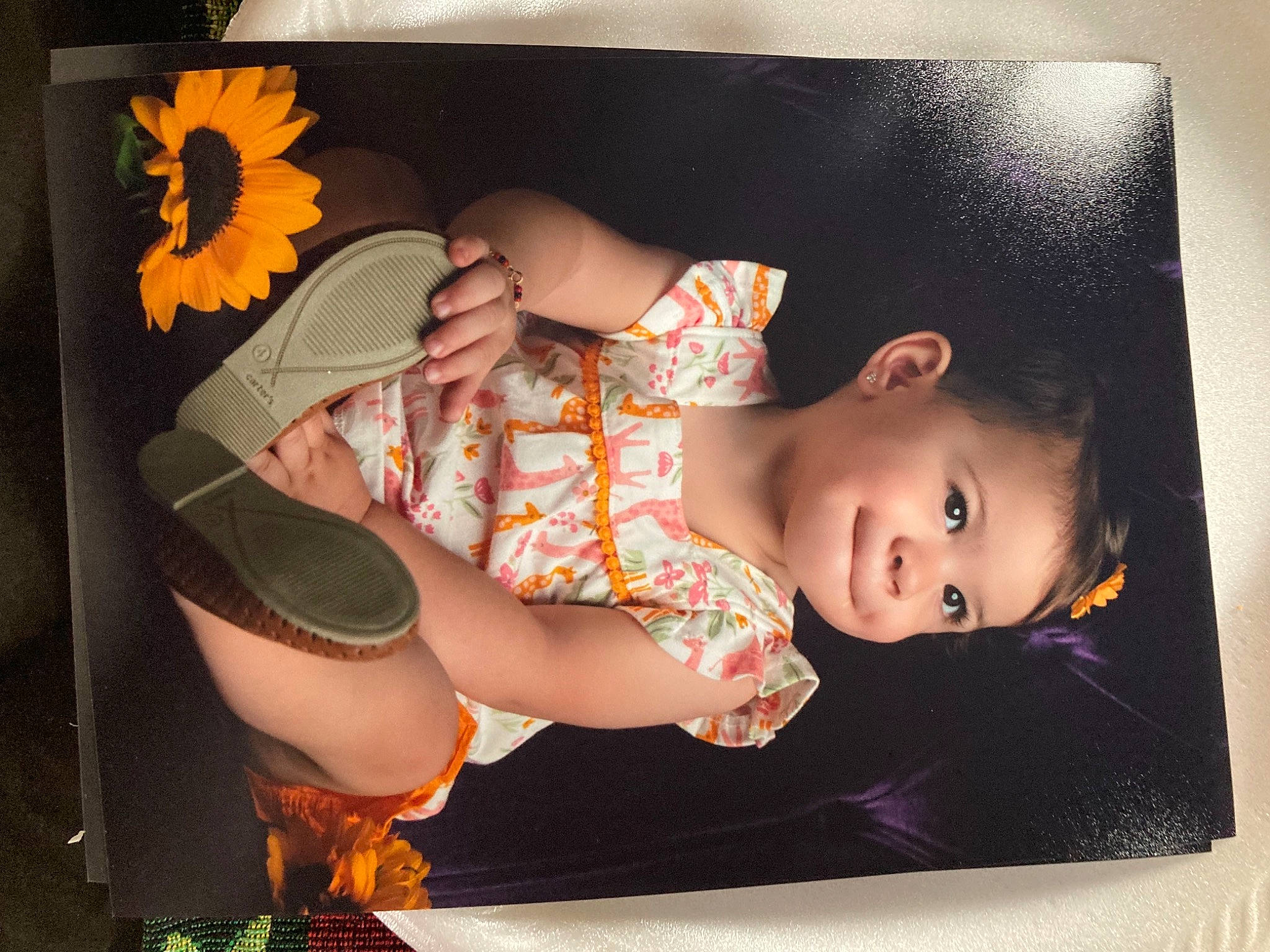 Ynnalee is registered to the contest to win money with this photo: baby, baby_products, baby_toddler_clothing, child, costume_accessory, ear, human, orange, peach, person, petal, stomach, sunflower, toddler