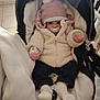 élie participe au concours pour gagner de l'argent avec cette photo : baby, babywear, blanket, child, clothing, comfort, cute, face, footwear, hat, indoor, infant, jacket, mittens, pacifier, person, seated, socks, stroller, warm