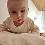élie participe au concours pour gagner de l'argent avec cette photo : baby, infant, face, closeup, indoor, soft, blanket, curious, wooden_ceiling, window, curtains, white_clothing, child, person, bedroom, home, furniture, room, young, portrait