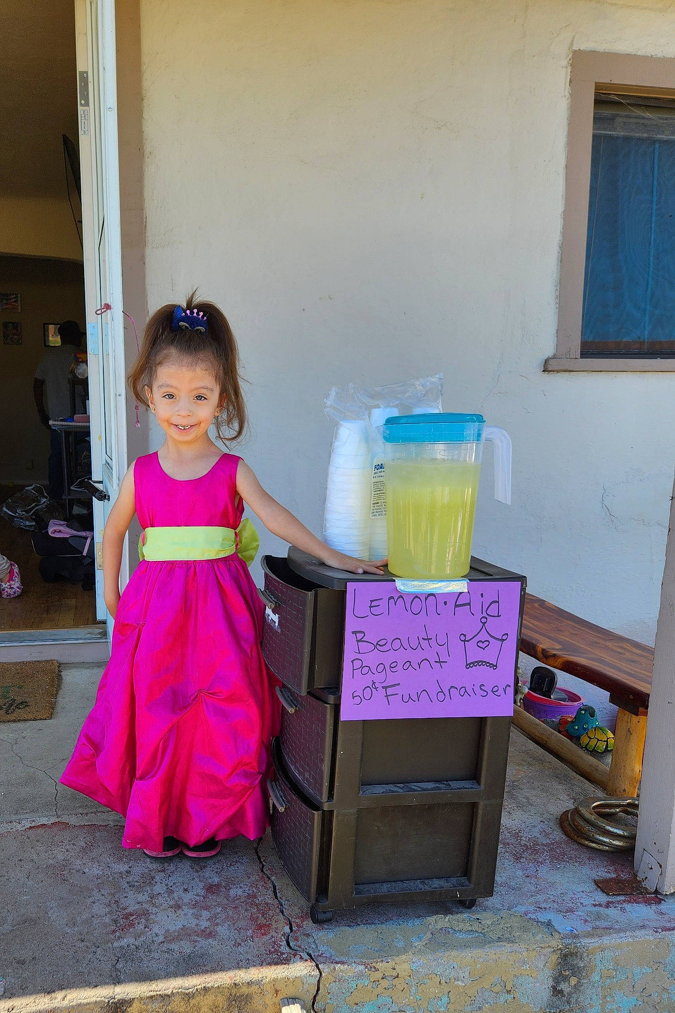 Ayanna is registered to the contest to win money with this photo: baby_toddler_clothing, child, door, dress, drink, event, flooring, formal_wear, fun, handwriting, happy, joy, magenta, person, purple, room, smile, toddler, window