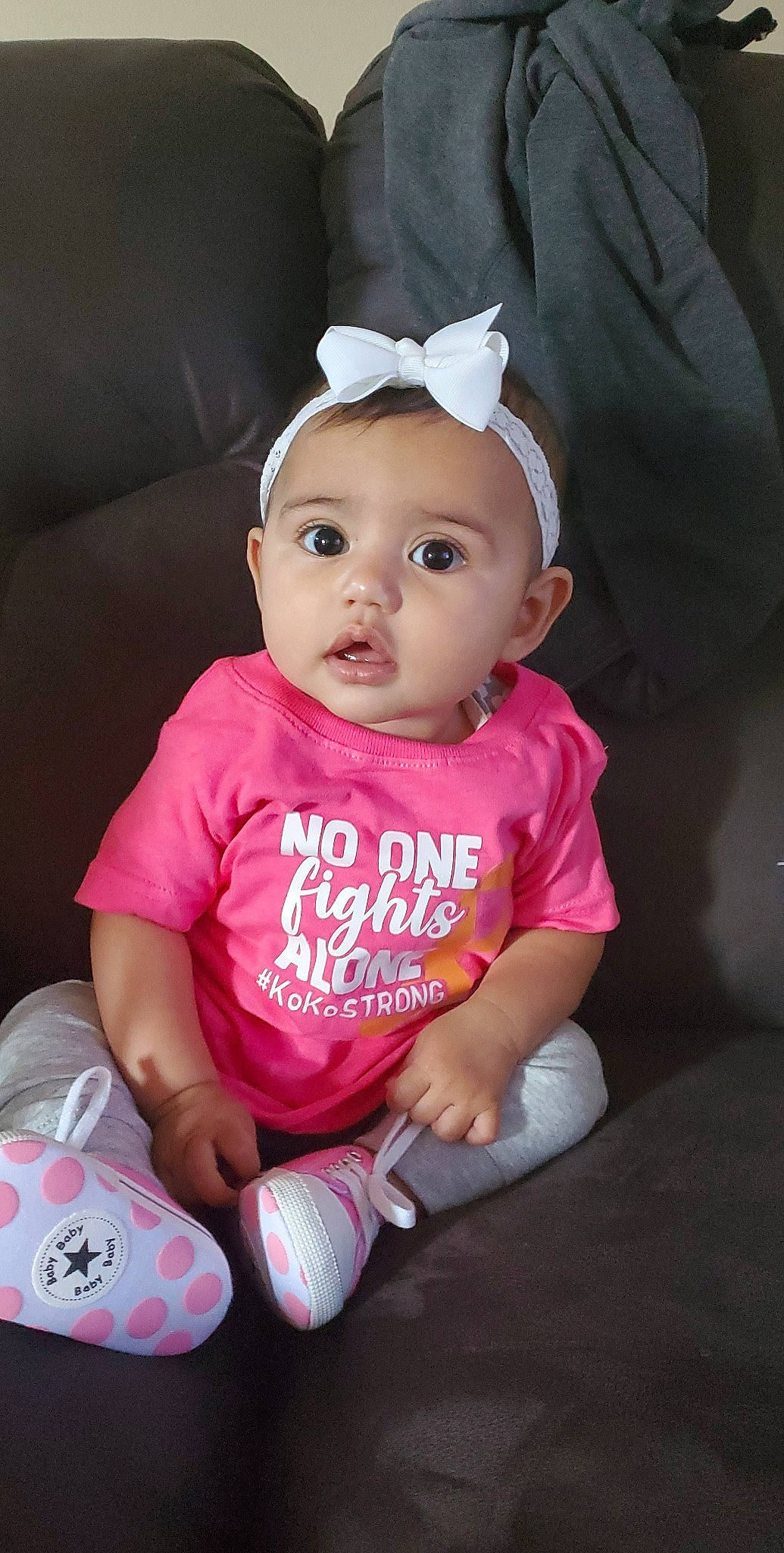 Gianna is registered to the contest to win money with this photo: baby, baby_products, baby_toddler_clothing, cheek, child, hair_accessory, headband, headgear, lip, person, pink, product, skin, surprise, toddler