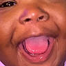 baby, child, infant, portrait, close_up, smiling, laughing, open_mouth, tongue, face, eyes, nose, pink_clothing, indoor, photography, happy, joyful, cute, headshot, black_borders