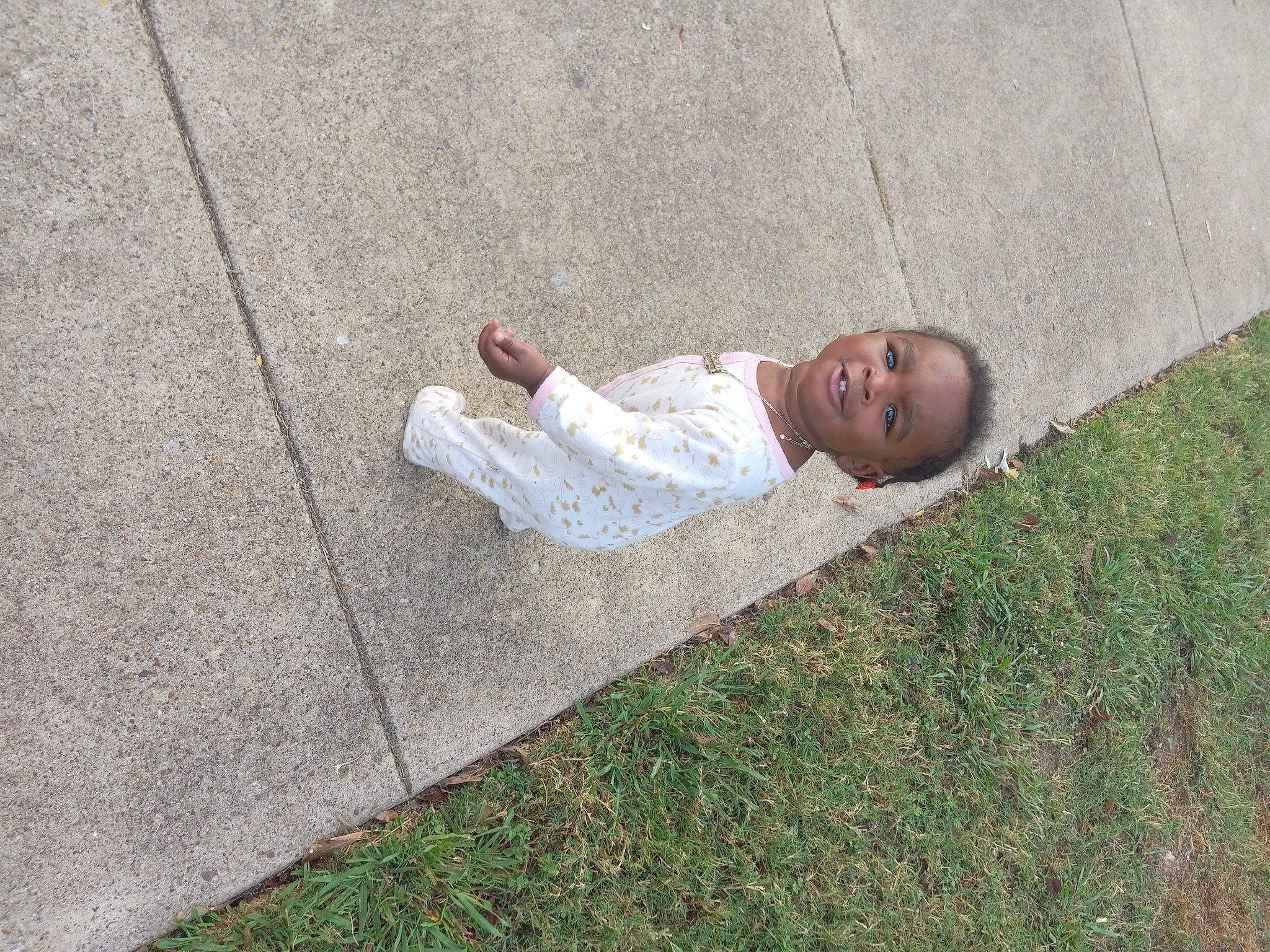 Aavanna joined the competition — help win amazing prizes! asphalt, child, concrete, curb, dress, flooring, foot, grass, grass_family, human_leg, joy, lawn, leisure, people_in_nature, person, road_surface, shadow, sidewalk, sitting, soil