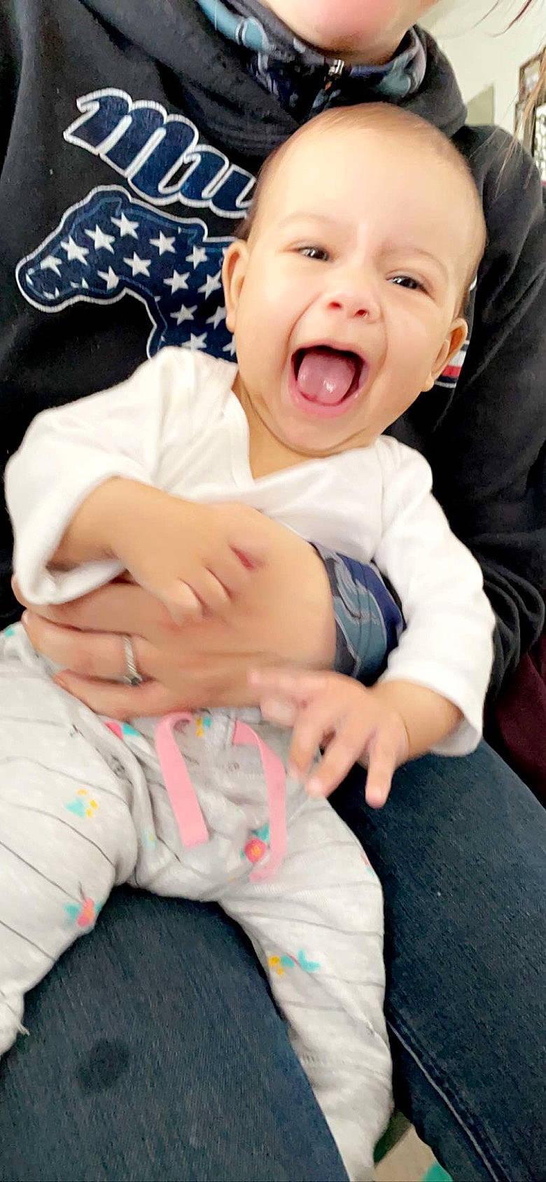 Ryder is registered to the contest to win money with this photo: baby, baby_toddler_clothing, cheek, comfort, eye, face, finger, gesture, happy, head, human_body, mouth, person, pink, skin, sleeve, smile, stomach, thumb, toddler