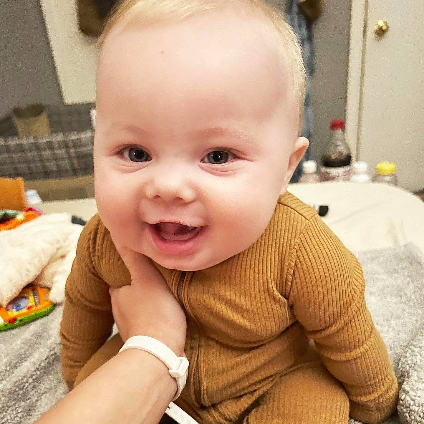 Oliver is registered to the contest to win money with this photo: arm, baby, baby_toddler_clothing, cheek, ear, eye, eyelash, gesture, happy, human_body, iris, lip, mouth, nose, person, skin, sleeve, smile, thumb, toddler