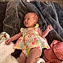 Savannah joined the competition — help win amazing prizes! baby, infant, blanket, clothing, floral, fabric, laying, person, cute, newborn, skin, foot, hand, face, indoors, soft, colorful, texture, relax, floor