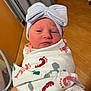 Savannah is registered to the contest to win money with this photo: newborn, baby, infant, wrapped, blanket, bow, hat, indoor, floor, curtain, person, portrait, cute, sleepy, child, hand, skin, headwear, maternity, hospital