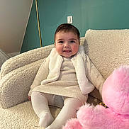 Rose participe au concours pour gagner de l'argent avec cette photo : armchair, baby, child, cozy, cute, furniture, happy, indoor, knitwear, lamp, person, pink_teddy_bear, plush, portrait, seated, smiling, soft_texture, toy, vest, wall