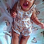 applique, baby, babylaughing, bodypart, clothing, dress, face, finger, furniture, hand, happy, head, mouth, newborn, pattern, person, photography, portrait, shorts, smile
