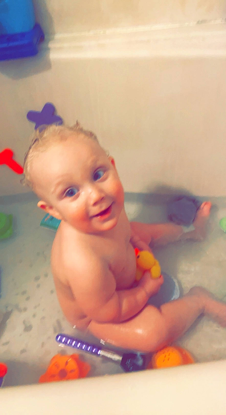 Dayton is registered to the contest to win money with this photo: arm, baby, baby_bathing, baby_playing_with_toys, bath_toy, bathing, bathroom, bathtub, cheek, fluid, fun, happy, head, iris, leisure, mouth, person, smile, toddler, toy