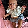Xareni joined the competition — help win amazing prizes! baby, child, smiling, white_top, blue_skirt, headband, gold_jewelry, bracelet, necklace, pink_blanket, heart_pattern, black_pillow, footwear, blue_shoes, lying_down, cute, happy, indoors, portrait, playful