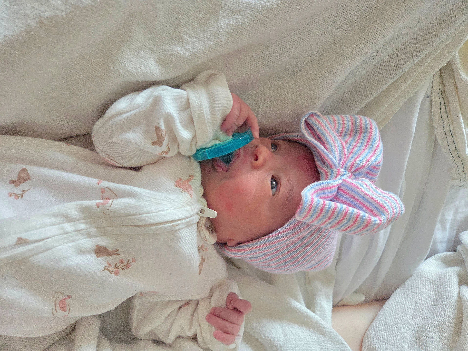 Luv'Mii is registered to the contest to win money with this photo: architecture, baby, bed, blanket, bodypart, bonnet, building, clothing, crib, face, finger, furniture, hand, hat, head, infantbed, newborn, person, photography, portrait