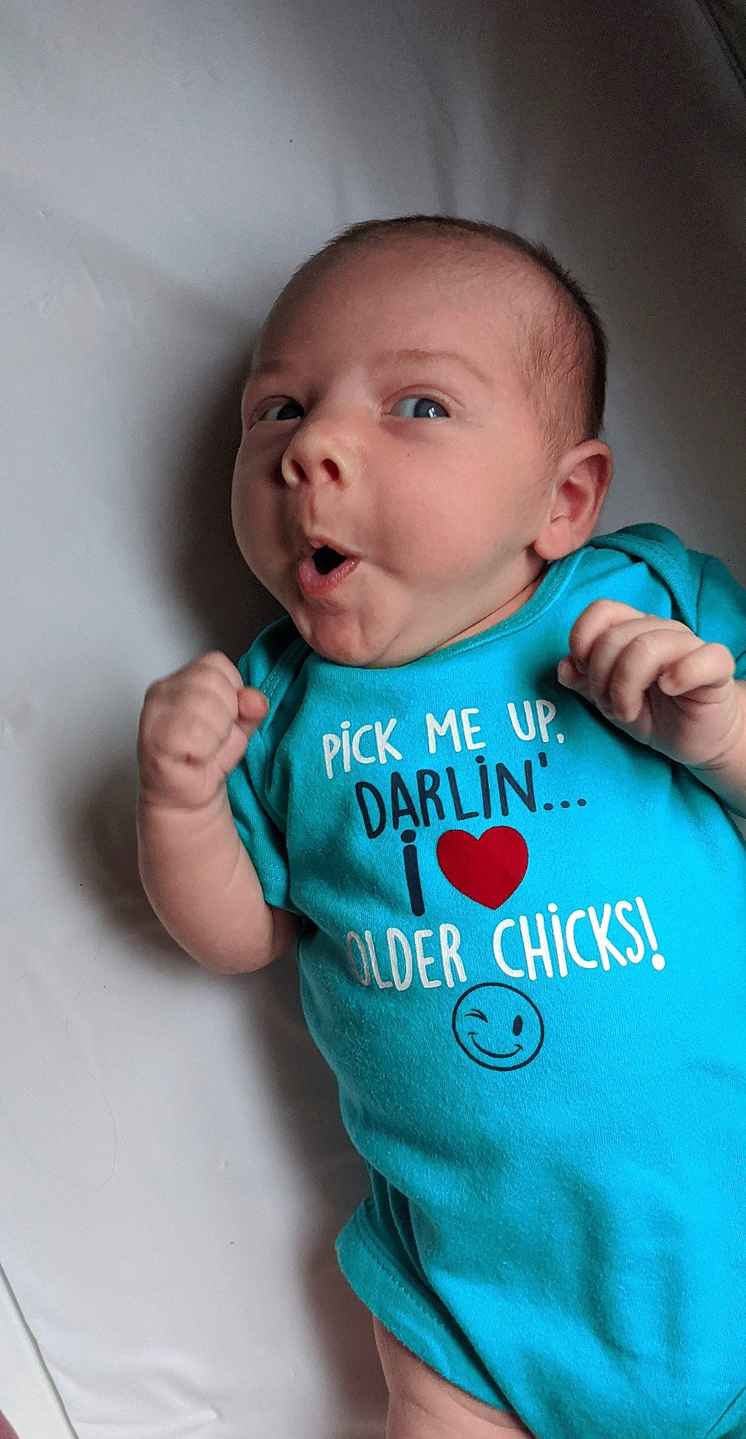 Kholson is registered to the contest to win money with this photo: baby, baby_toddler_clothing, cheek, clothing, collar, cool, eyebrow, facial_expression, finger, gesture, hairstyle, happy, iris, mouth, neck, nose, person, skin, sleeve, t_shirt