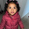 Milaní joined the competition — help win amazing prizes! child, toddler, puffer_jacket, pink_clothing, curly_hair, hair_clips, indoors, carpeted_floor, snack, bag_of_chips, wide_eyes, looking_up, cute, winter_clothing, small_hand, portrait, casual, standing, expression, person