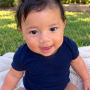 Mason joined the competition — help win amazing prizes! baby, child, infant, portrait, sitting, smiling, happy, outdoors, garden, grass, blanket, navy_shirt, short_sleeves, dark_hair, brown_eyes, face, close_up, sunlight, greenery, photography