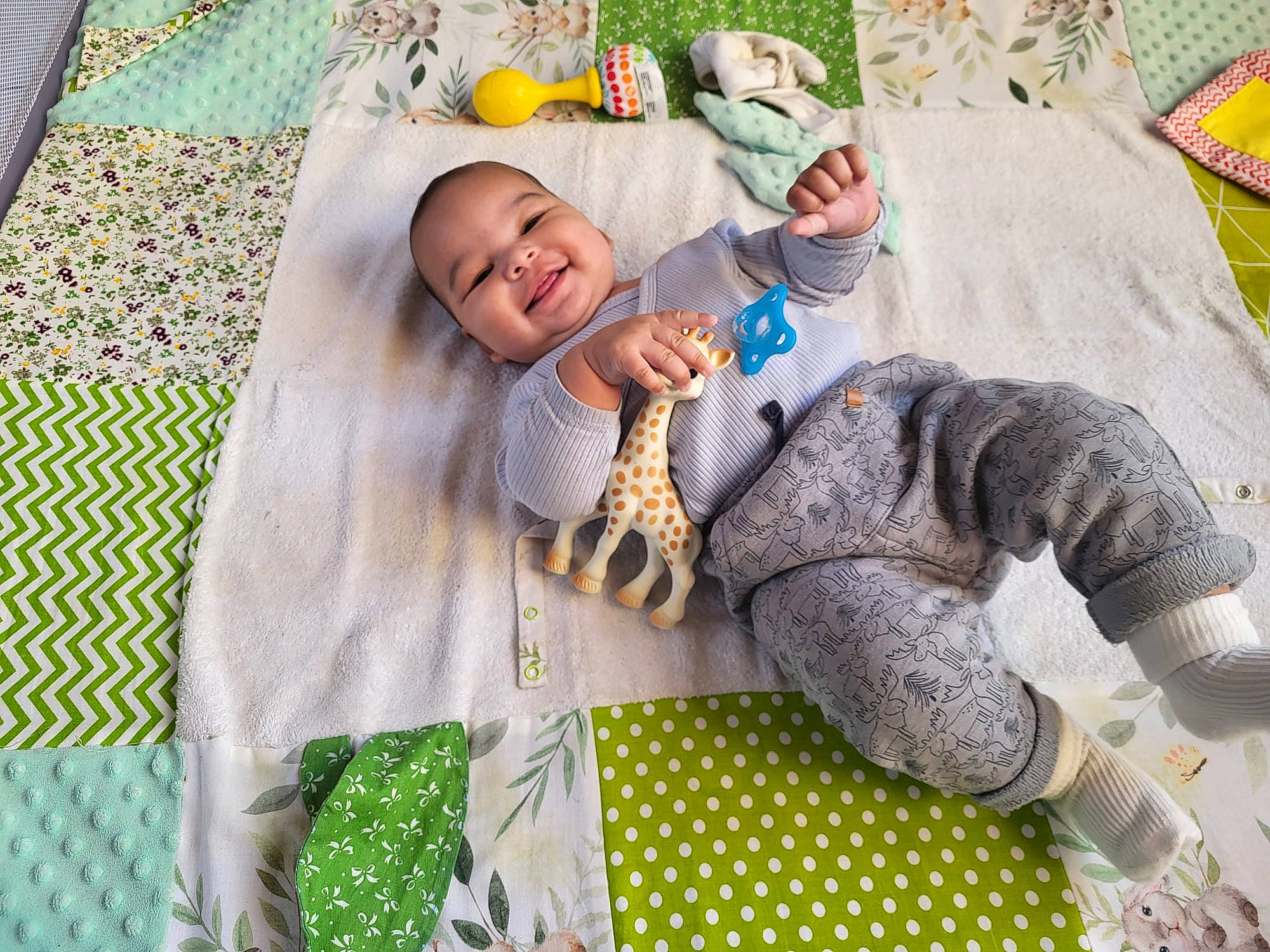 Mylan a rejoint le concours — aidez-le/la à gagner de superbes lots ! baby, baby_products, baby_sleeping, baby_toddler_clothing, bedding, child, comfort, fun, grass, green, happy, linens, pattern, person, sleeve, smile, stuffed_toy, textile, toddler, toy