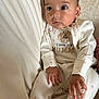 Pippin is registered to the contest to win money with this photo: baby, chair, child, clothing, comfortable, cozy, cute, expression, face, giraffe, hands, indoor, infant, onesie, person, portrait, sitting, soft_fabric, stars, young_child