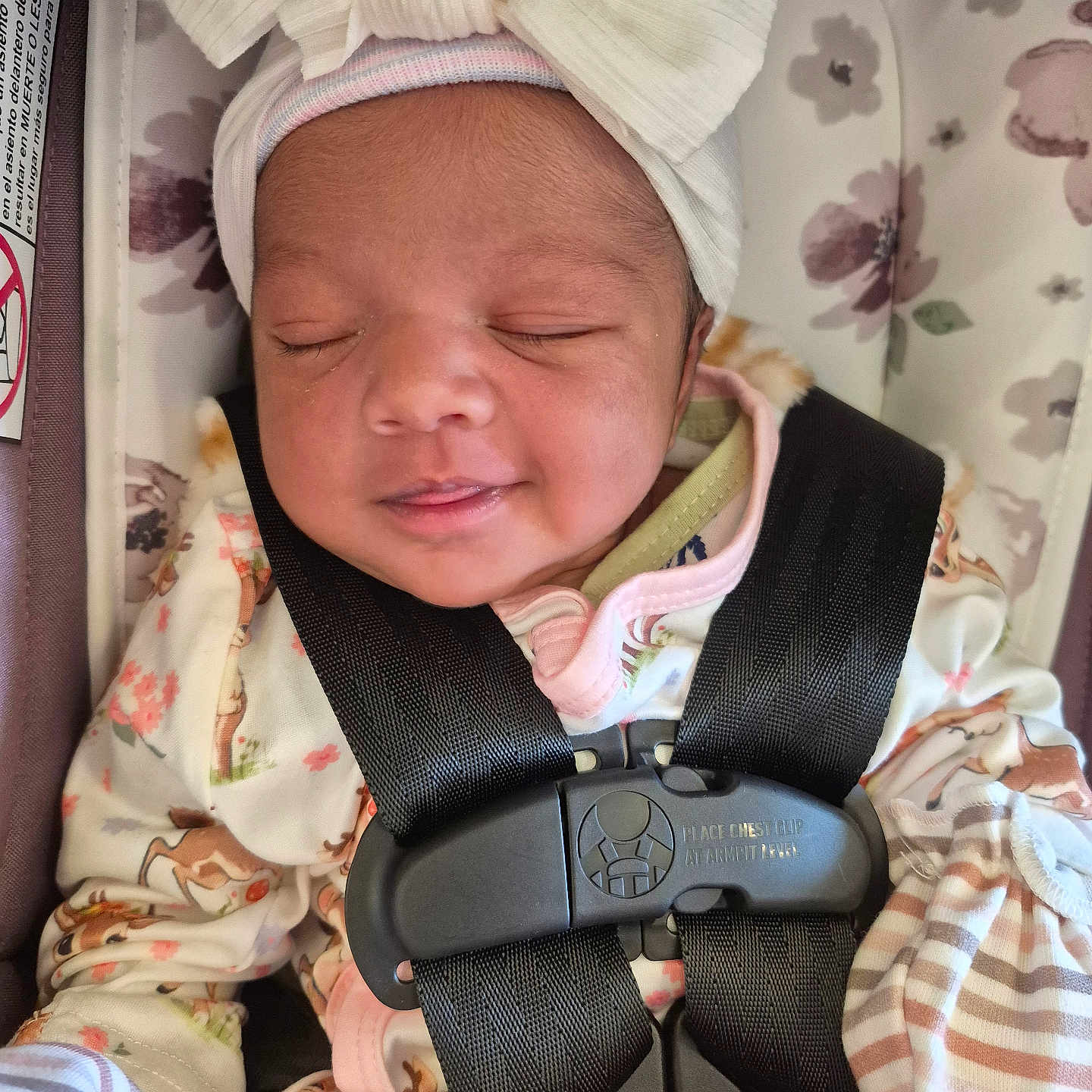 Arwa is registered to the contest to win money with this photo: baby, bow, car_seat, child, closeup, cute, floral, headband, indoors, infant, newborn, pajamas, pattern, peaceful, resting, safety_harness, sleeping, smiling, soft_lighting, toddler