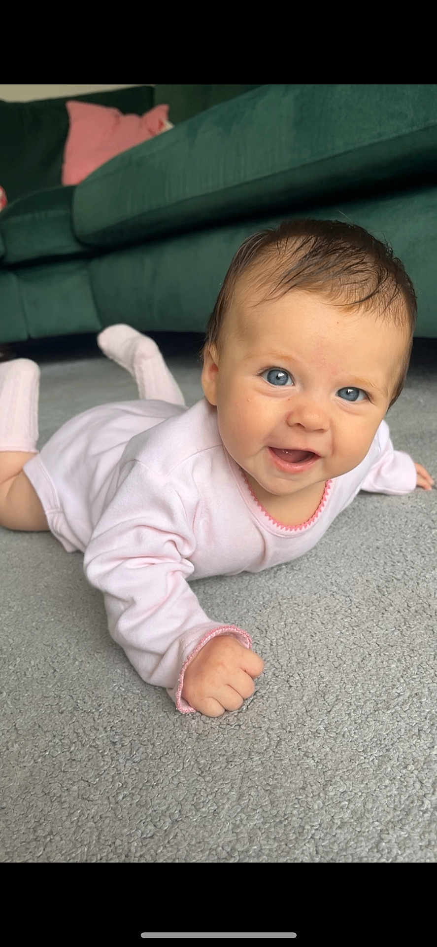 Pixie joined the competition — help win amazing prizes! baby, infant, smiling, lying_down, pink_clothing, carpet, indoor, couch, pillow, happy, cute, child, face, skin, hair, eyes, hand, footwear, home, portrait