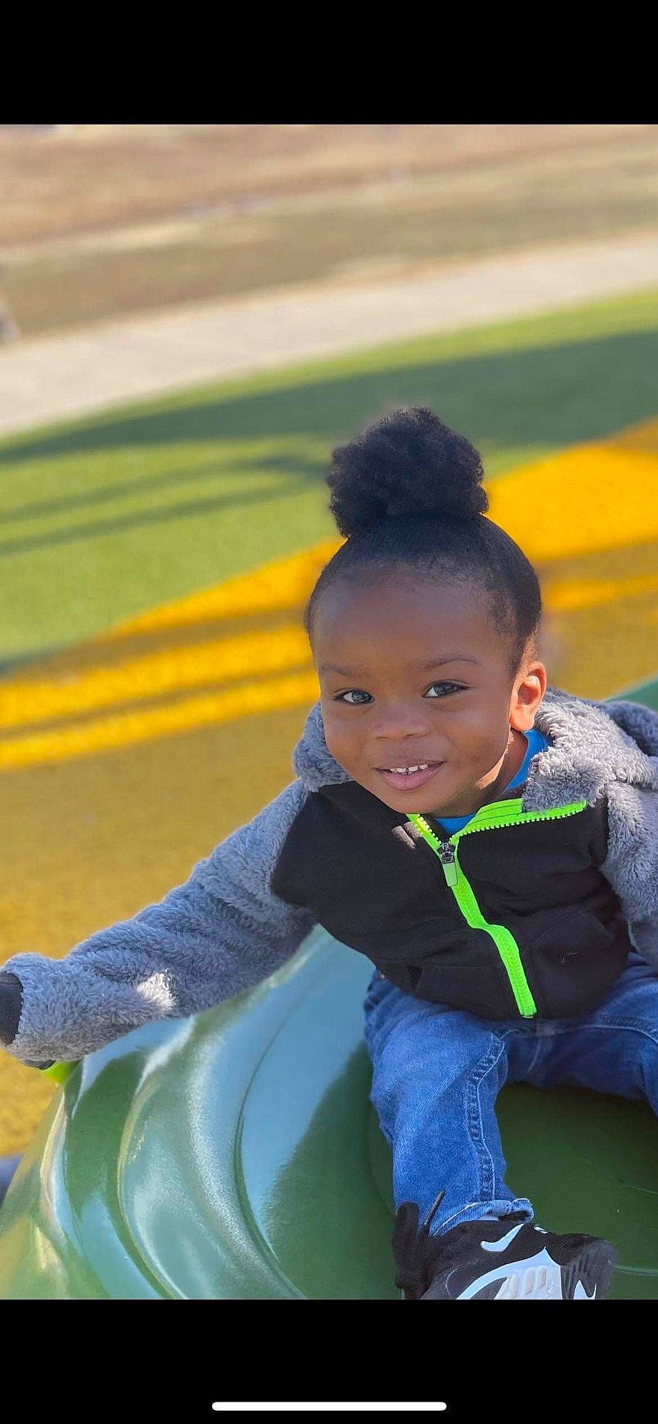 Jamareontae is registered to the contest to win money with this photo: child, competition_event, electric_blue, fun, grass, happy, hoodie, joy, leisure, person, personal_protective_equipment, play, player, recreation, sitting, smile, standing, team_sport, toddler