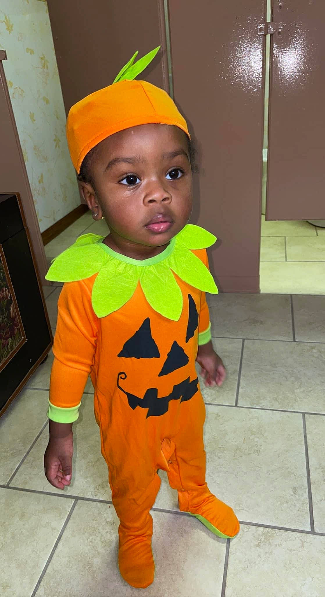 Jamareontae is registered to the contest to win money with this photo: baby_toddler_clothing, cap, child, costume, costume_hat, fashion_accessory, fashion_design, fictional_character, flooring, fun, happy, head, mascot, orange, outerwear, person, personal_protective_equipment, room, toddler, trick_or_treat
