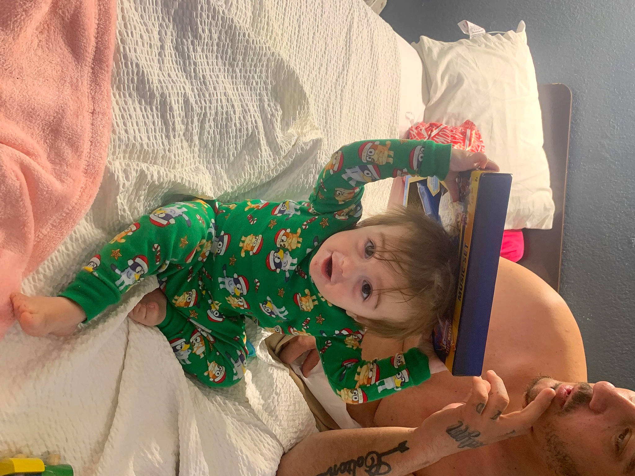 Joseph Jr. is registered to the contest to win money with this photo: abdomen, child, comfort, costume, event, fictional_character, happy, human_leg, linens, pattern, person, room, thigh, toddler, wrist