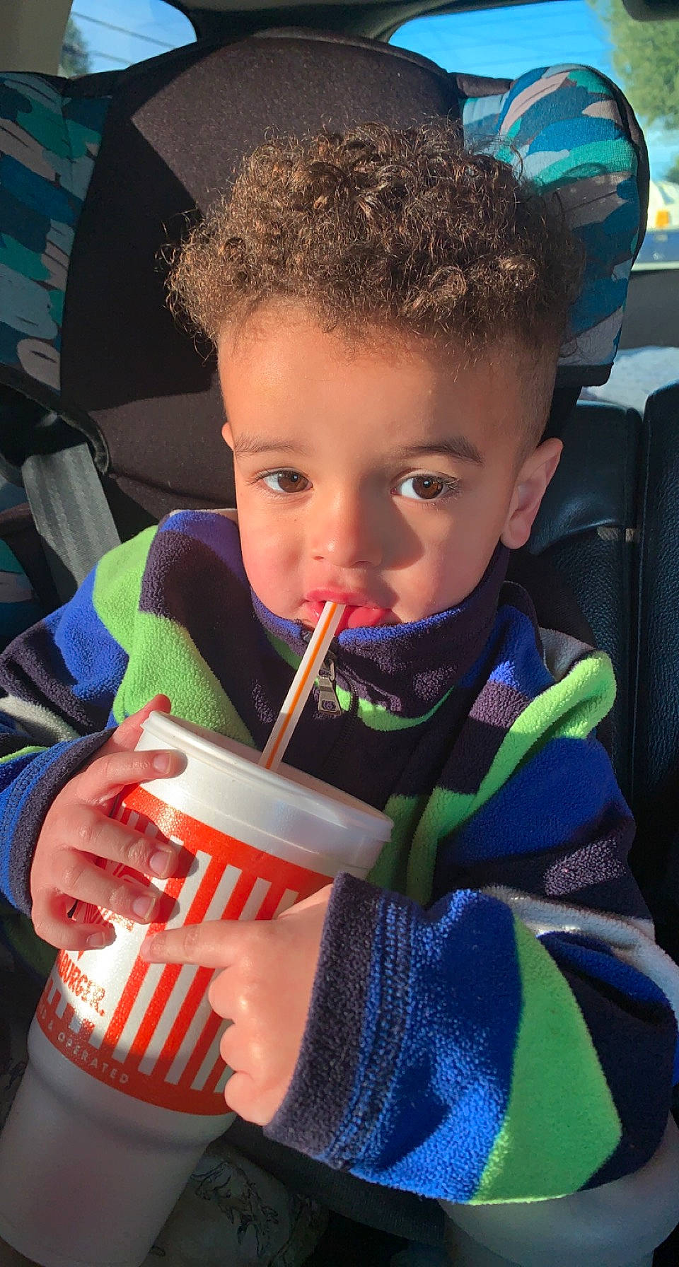 Keaton is registered to the contest to win money with this photo: child, cup, drink, drinking, drinking_straw, drinkware, fun, happy, junk_food, person, photography, play, soft_drink, sweetness, tableware, toddler, vacation