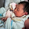 Aryanna Lott is registered to the contest to win money with this photo: newborn, baby, sleeping, infant, face, portrait, plush_toy, stuffed_animal, blanket, bedding, nursery, indoors, close_up, dark_hair, closed_eyes, peaceful, cuddling, onesie, soft_lighting, photography