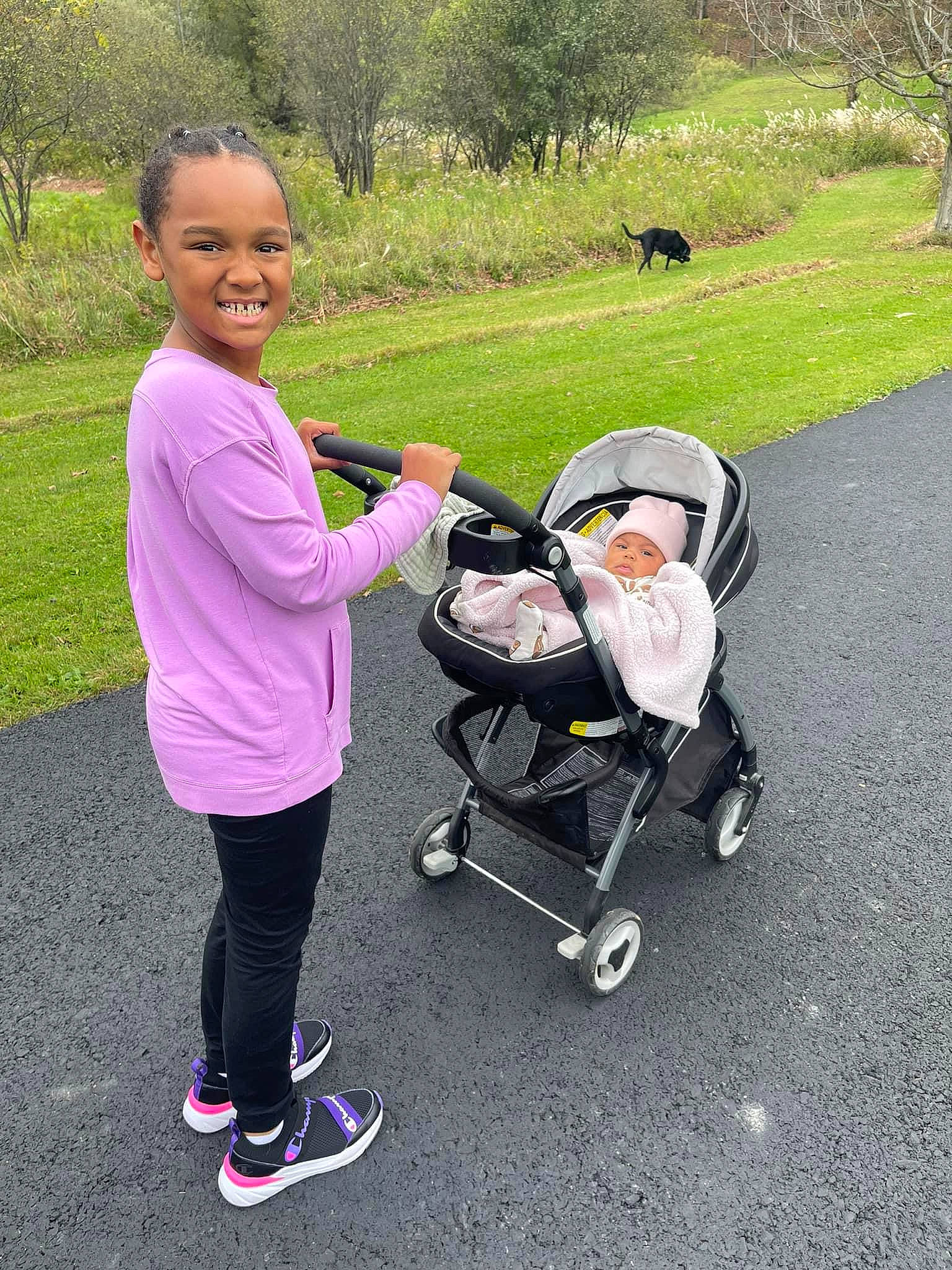 Jaela joined the competition — help win amazing prizes! asphalt, baby_carriage, baby_products, child, fun, grass, happy, headwear, joy, leisure, people_in_nature, person, plant, recreation, rolling, shoe, smile, sneakers, tire, toddler