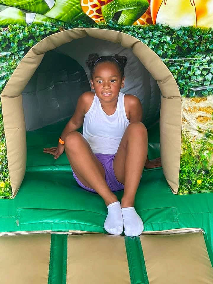 Jaela is registered to the contest to win money with this photo: child, comfort, fun, grass, green, happy, human_leg, knee, leisure, outdoor_play_equipment, people_in_nature, person, photograph, plant, playground, recreation, shorts, snapshot, summer, thigh