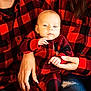 baby, child, infant, family, plaid, red_and_black, matching_outfits, hands, jeans, ripped_jeans, person, casual_clothing, indoor, portrait, smiling, closeup, holding, cozy, cute, warm