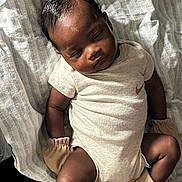 Kashmir is registered to the contest to win money with this photo: baby, sleeping, onesie, mittens, blanket, infant, child, soft, cozy, peaceful, resting, cute, portrait, indoor, newborn, clothing, closeup, skin, head, legs