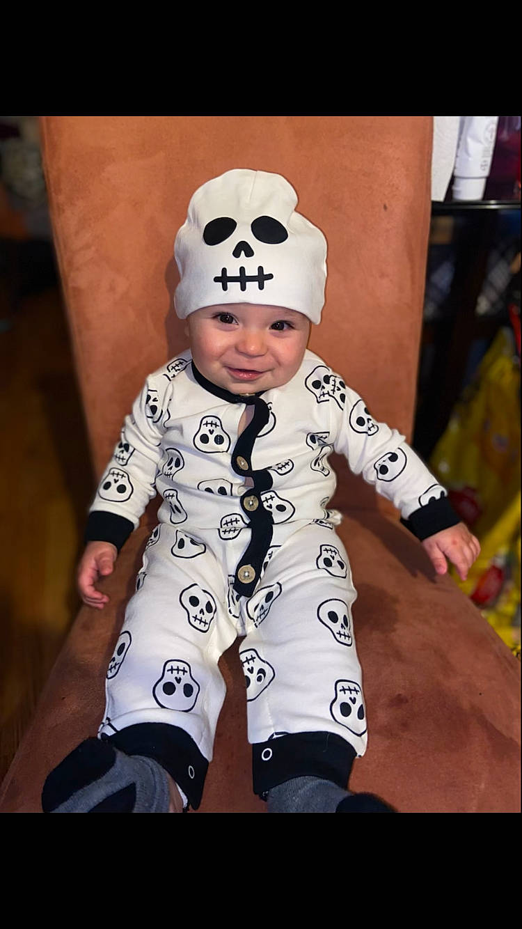 Hezekiah is registered to the contest to win money with this photo: baby, baby_toddler_clothing, beanie, cap, child, costume, costume_hat, eyewear, fashion_accessory, fur, happy, headwear, pattern, person, personal_protective_equipment, portrait_photography, recreation, sitting, sleeve, smile