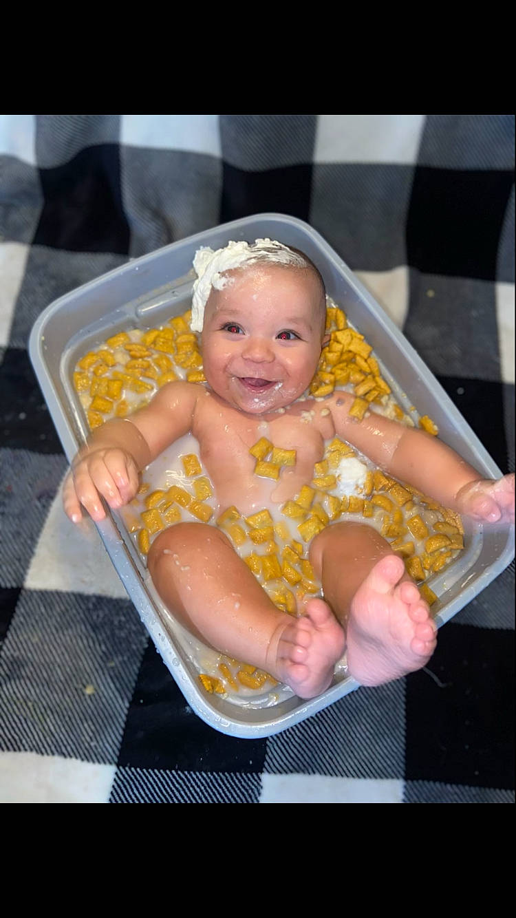 Hezekiah is registered to the contest to win money with this photo: baby, baby_carriage, baby_products, baby_safety, baby_toddler_clothing, chair, child, comfort, event, fun, happy, joy, lap, leisure, person, sitting, smile, thumb, toddler, vacation